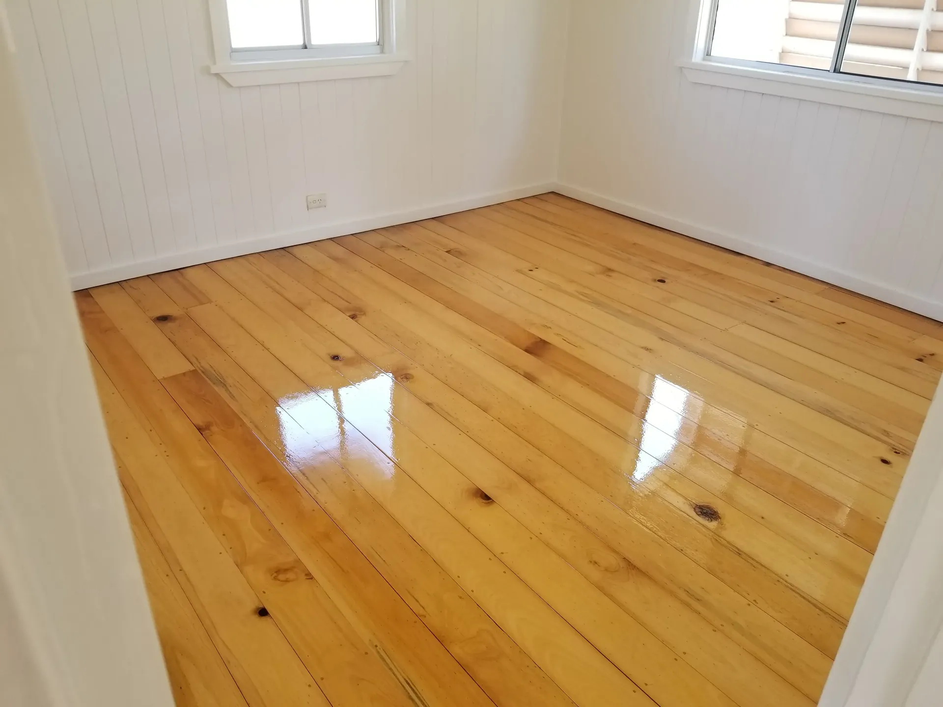 Empty Room With Polished Wood Floor and White Walls — The Good Wood Polished Timber Floors in Highfields, QLD