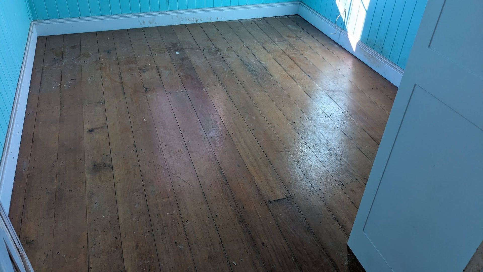 Empty Room With Polished Wood Floor and White Walls — The Good Wood Polished Timber Floors in Highfields, QLD