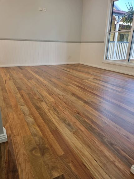 Empty Room With Wood-look Flooring, White Walls, and a Glass Door — The Good Wood Polished Timber Floors in Highfields, QLD