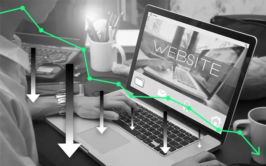 A person is using a laptop computer with a website on the screen.