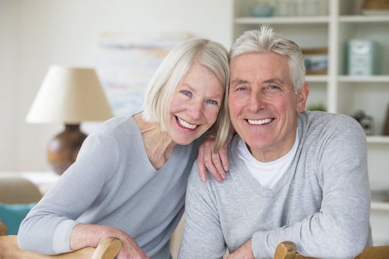 Dentist Showing Teeth Dentures to a Senior Patient — Central PA — Denture Center