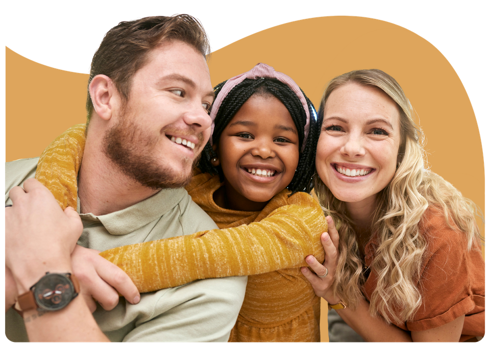 Three smiling people posing together on a white background with an orange shape behind them
