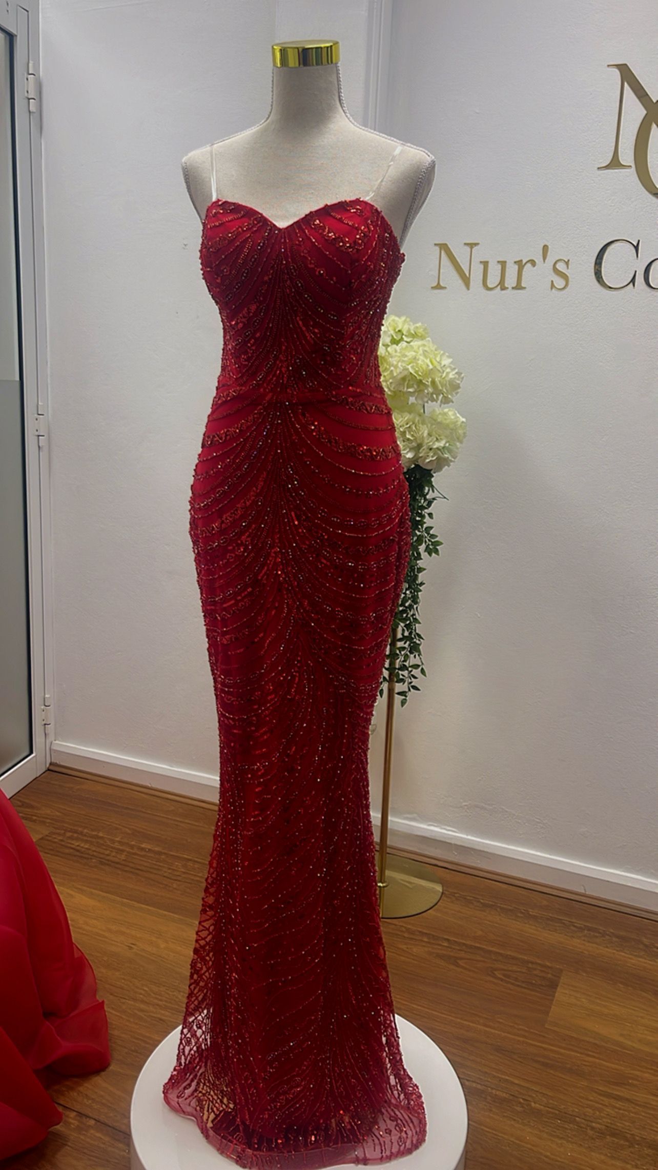 Red Sequined Strapless Evening Gown on a Mannequin in a Boutique Display — Nur's Collection In Rockdale, NSW