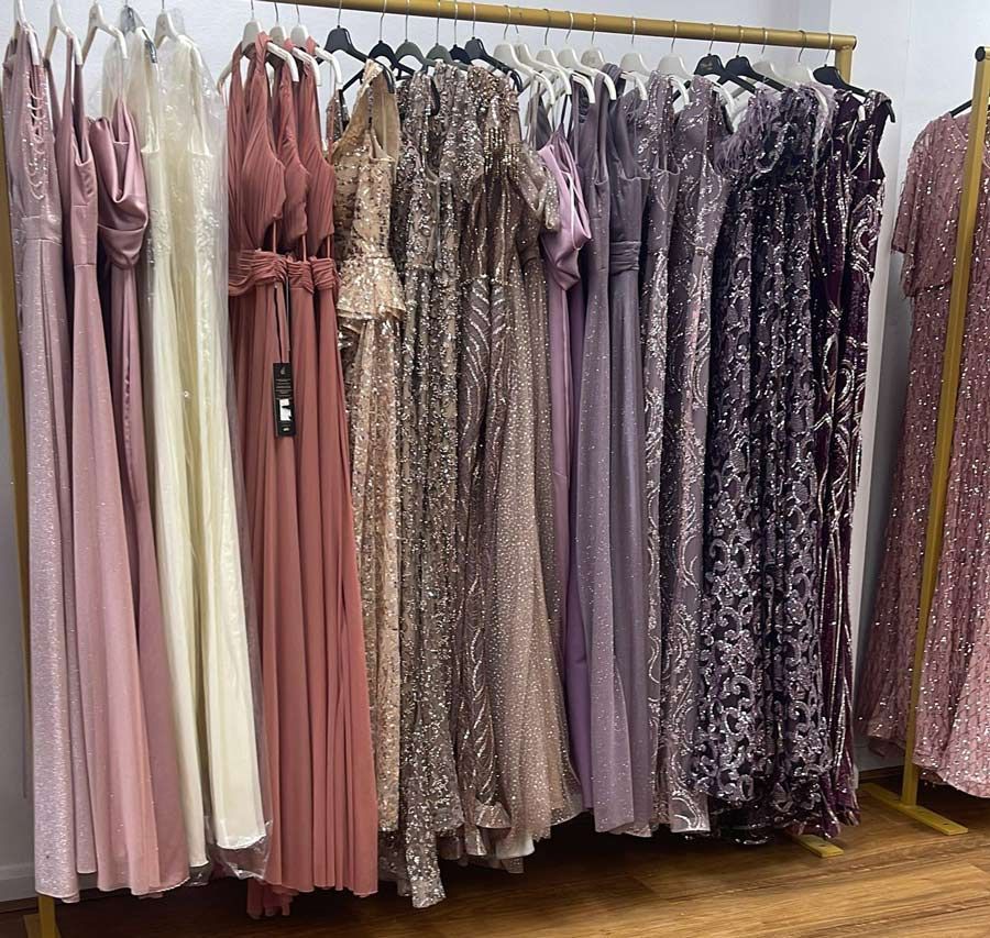 Pastel and Glittery Long Dresses Hanging on a Clothing Rack in a Boutique — Nur's Collection In Rockdale, NSW