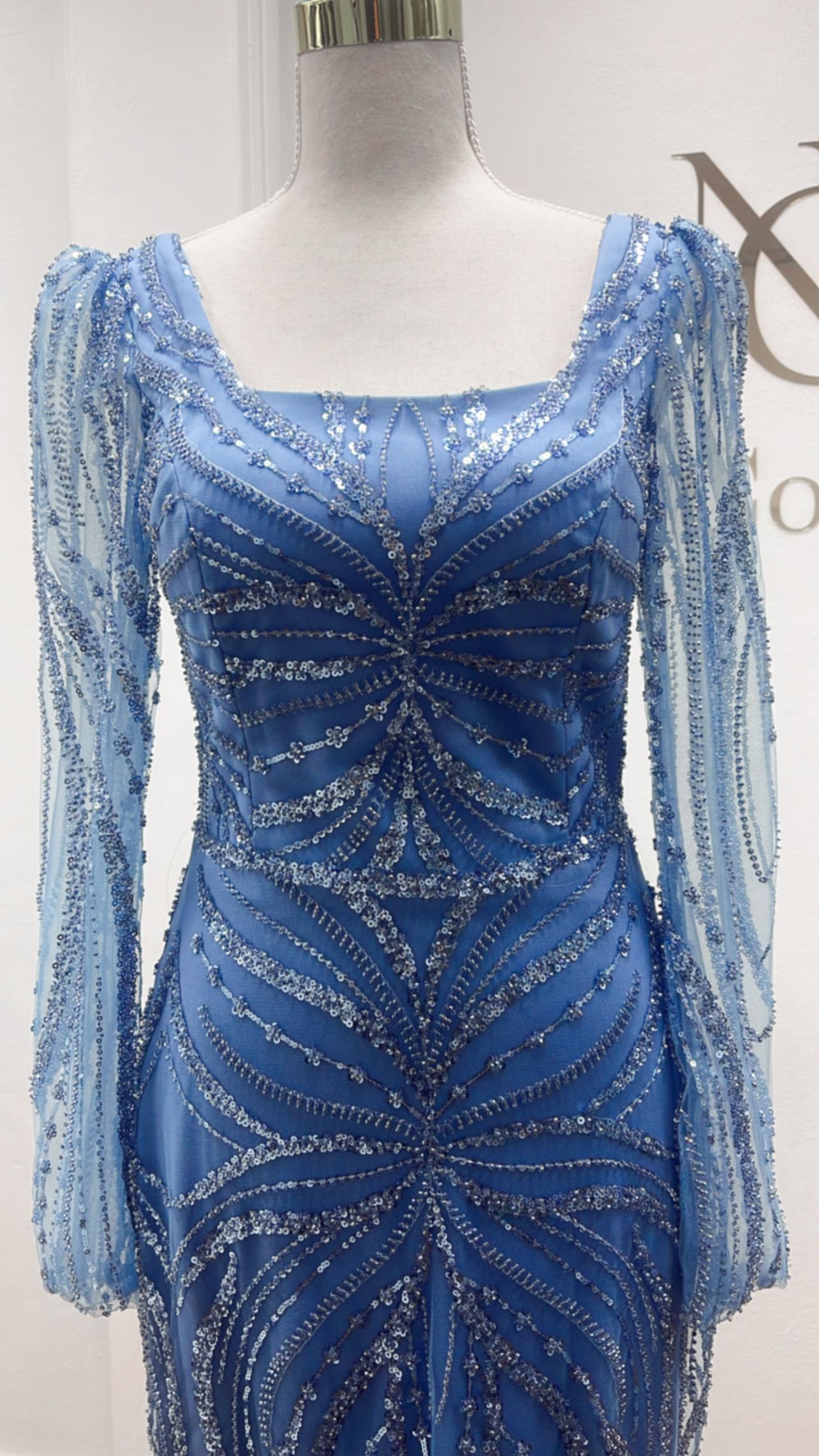 Blue Beaded Long-sleeve Evening Gown on a Mannequin โ Nur's Collection In Rockdale, NSW