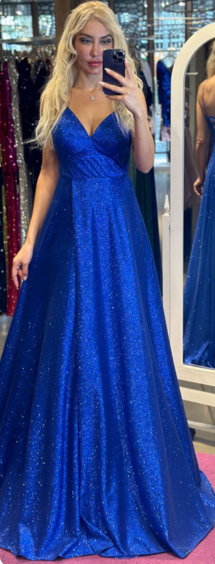 Woman in a Sparkly Blue Gown Taking a Mirror Selfie in a Fitting Room โ Nur's Collection In Rockdale, NSW