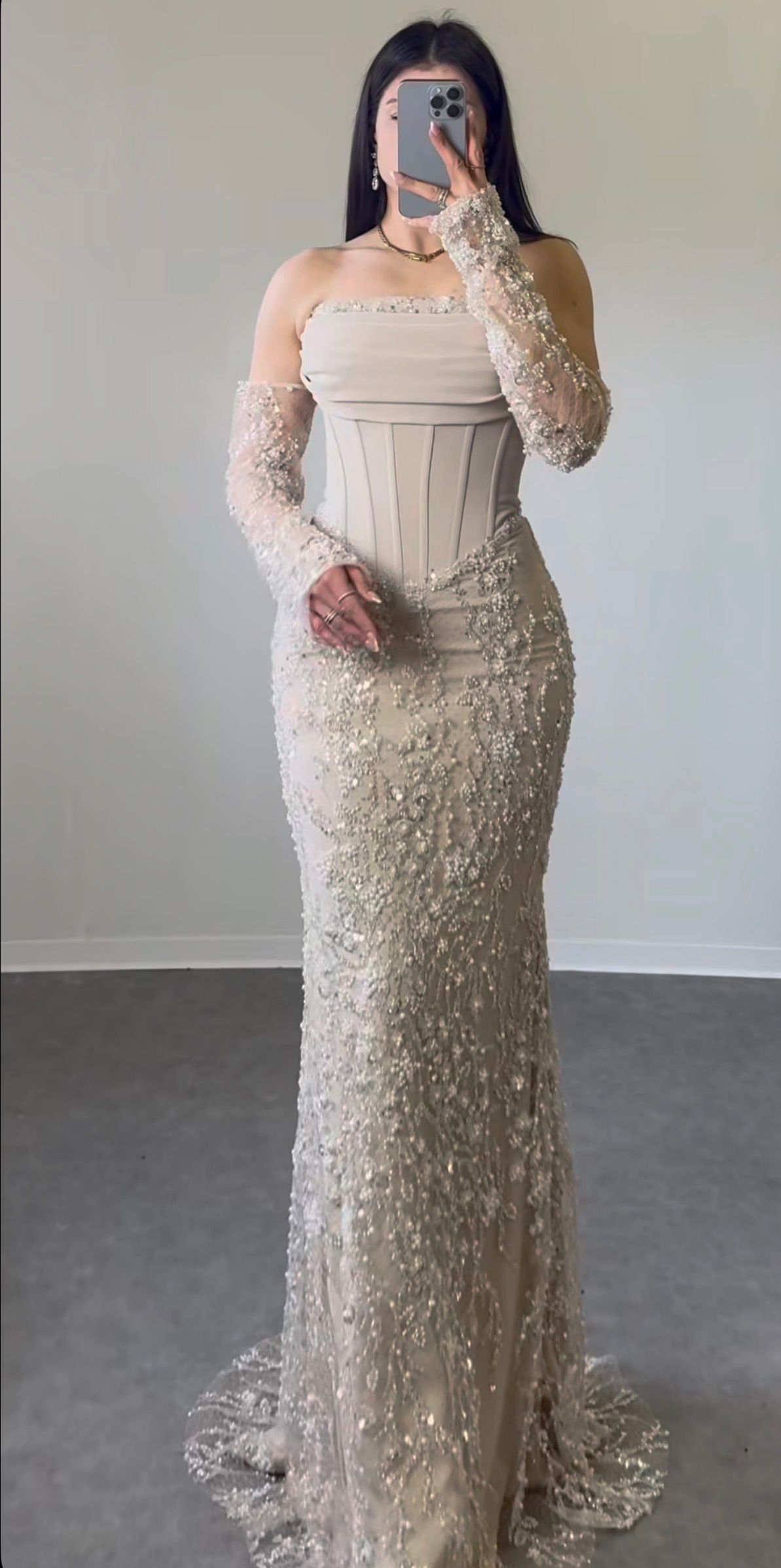 Person in a Cream Beaded Gown Taking a Mirror Selfie Indoors — Nur's Collection In Rockdale, NSW