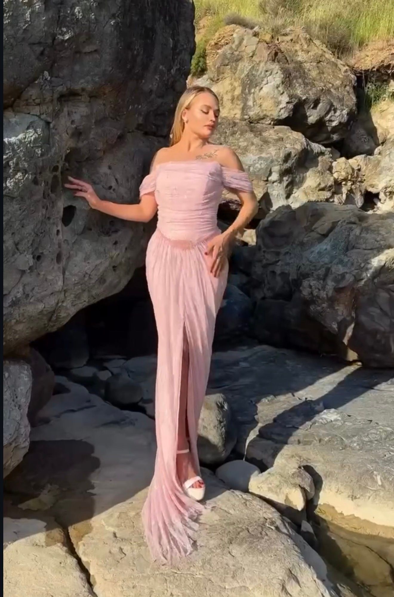 Woman in a Pink Off-shoulder Gown Posing on Rocks by a Cliffside — Nur's Collection In Rockdale, NSW
