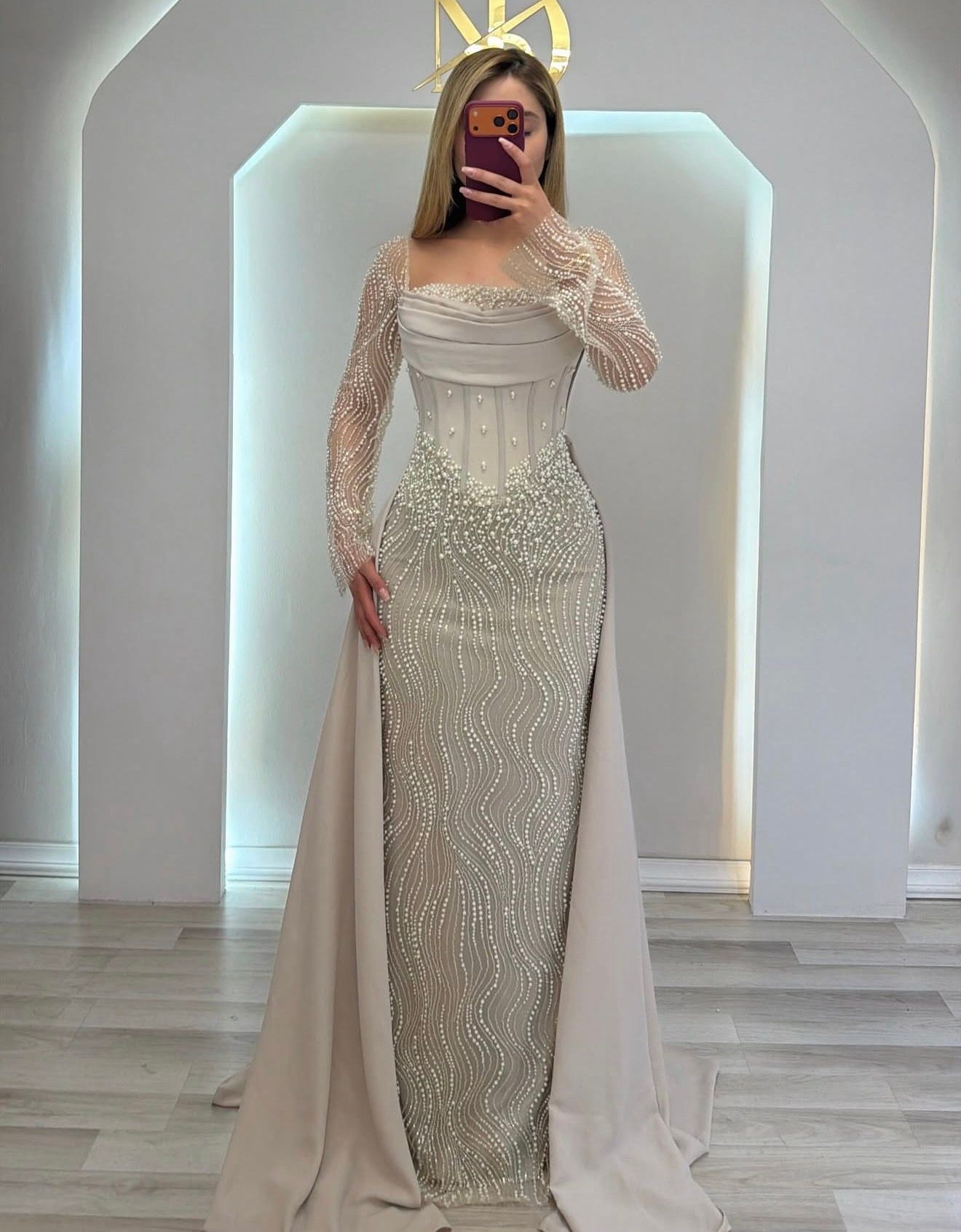Woman in a Sparkling Silver Gown With Sheer Cape Sleeves — Nur's Collection In Rockdale, NSW