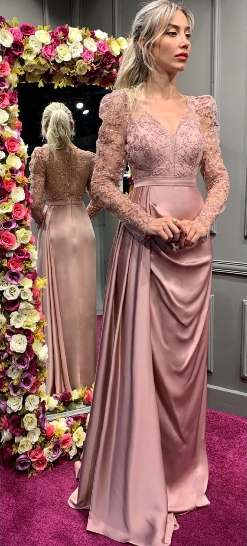 Woman in a Pink Lace Gown Standing Beside a Floral Display and Her Reflection in a Mirror — Nur's Collection In Rockdale, NSW