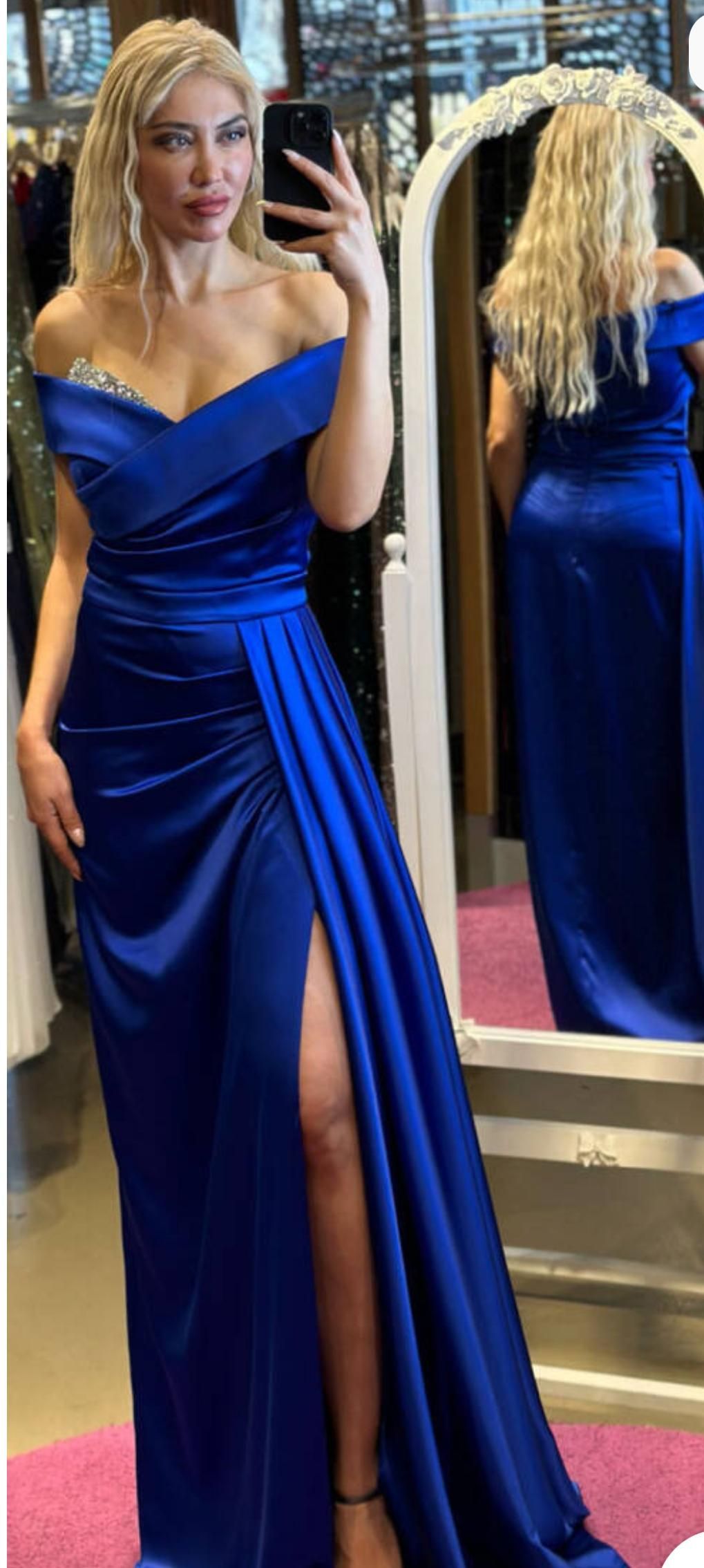 Woman in a Cobalt Blue Gown Posing Beside a Mirror in a Boutique Dressing Area — Nur's Collection In Rockdale, NSW