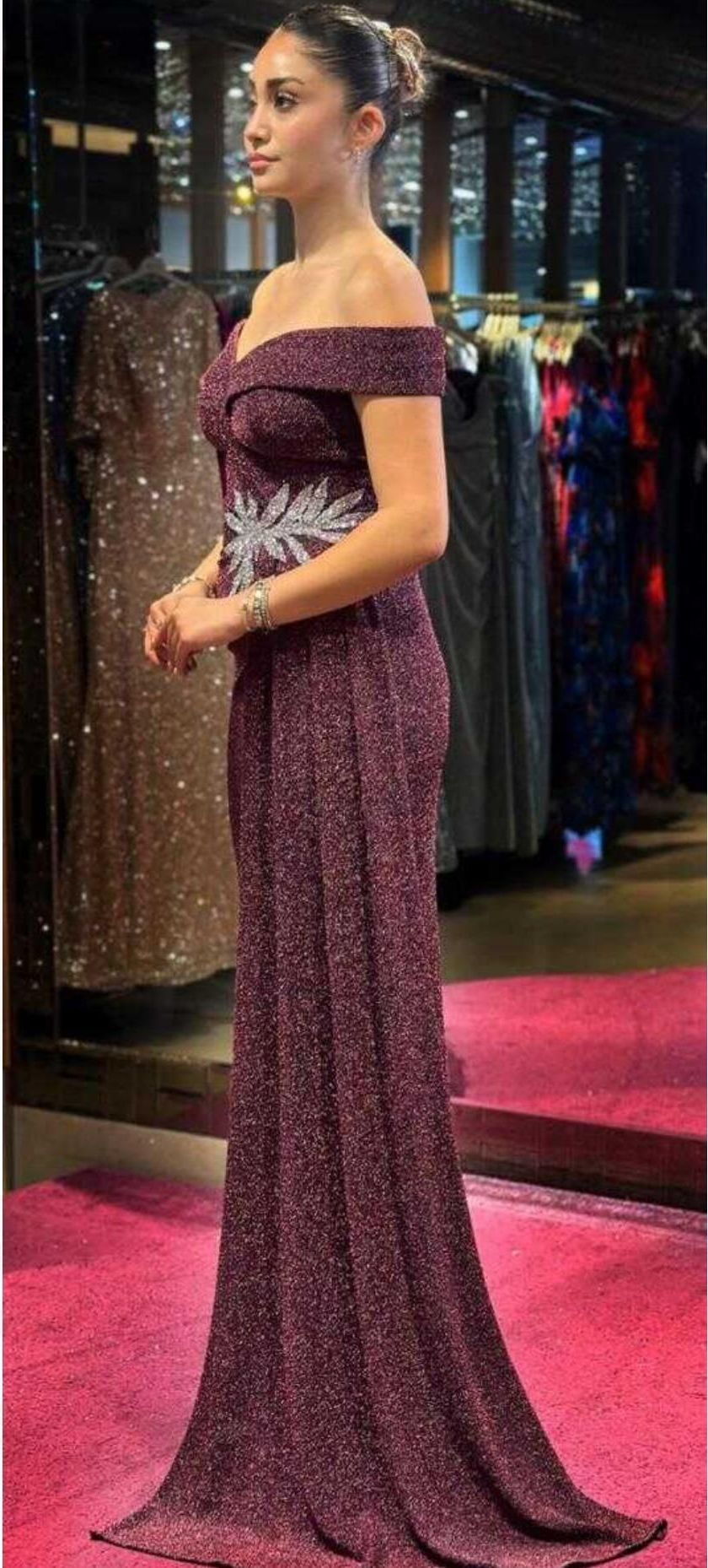 Woman in a Long Burgundy Off-shoulder Gown Standing on a Pink Carpet โ Nur's Collection In Rockdale, NSW