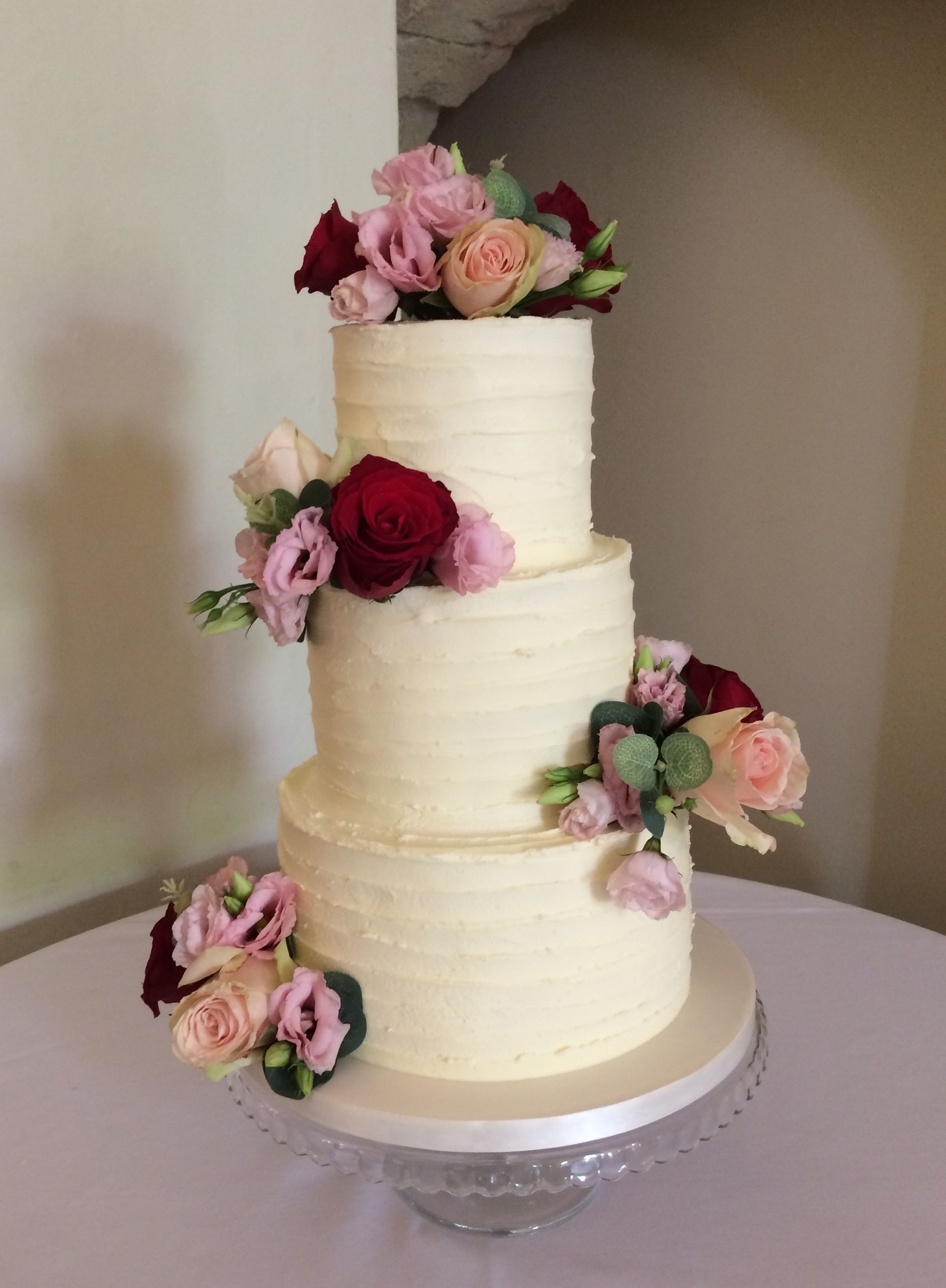 buttercream wedding cake with fresh flowers