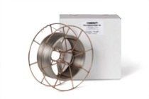 A spool of welding wire is sitting next to a box.