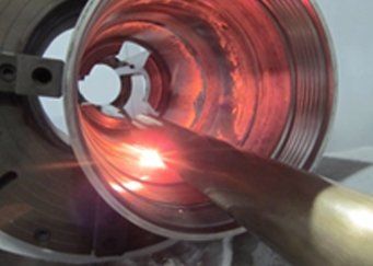 A red light is shining on a metal object