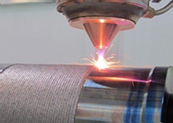 A machine is cutting a piece of metal with a laser.