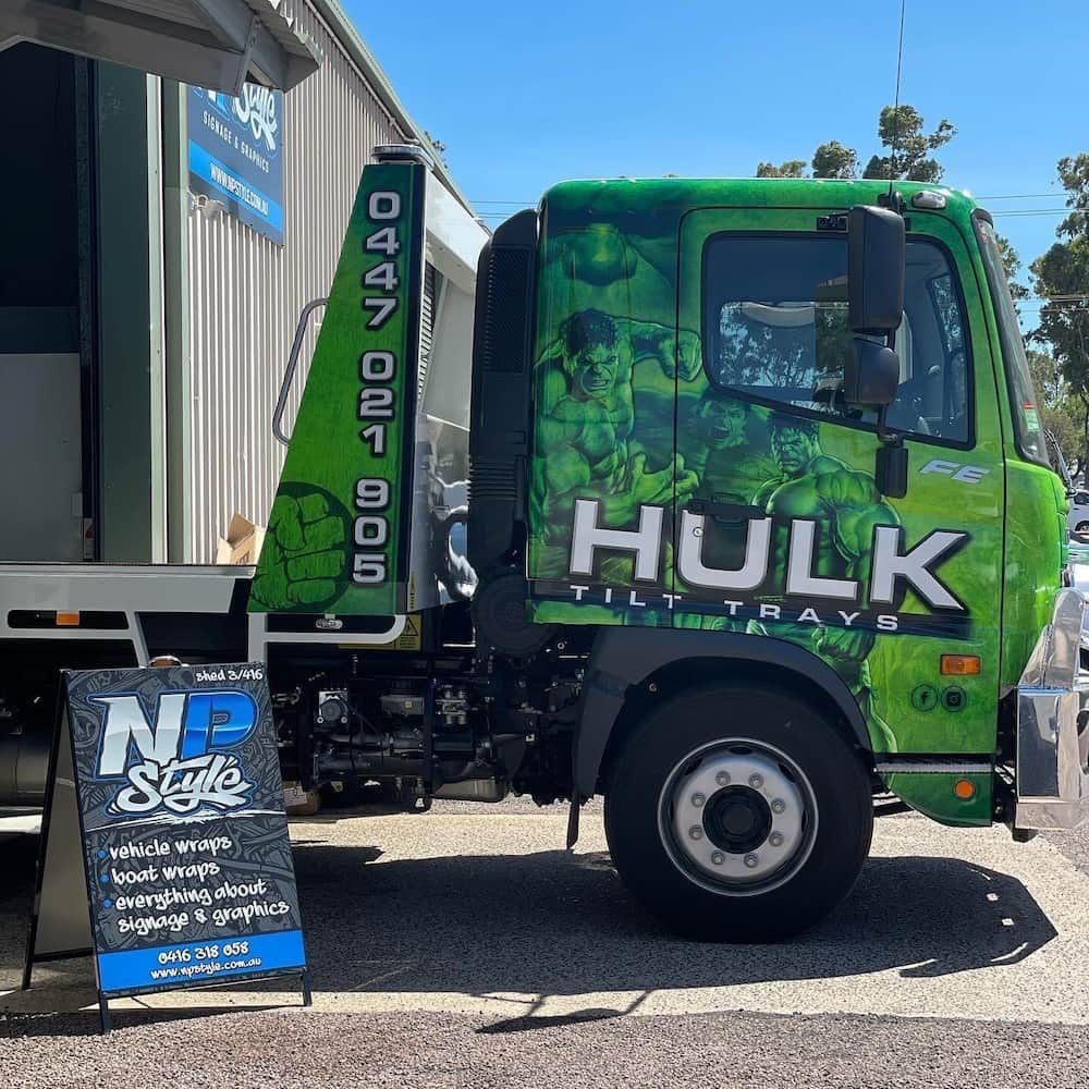 A Green Hulk Tow Truck Is Parked in Front of A Building — Hulk Tilt Trays In Humpty Doo, NT