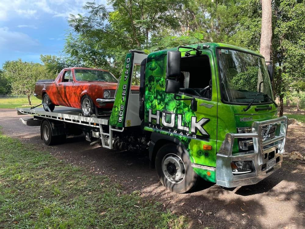 A Green Tow Truck with A Red Car on The Back of It — Hulk Tilt Trays In Humpty Doo, NT