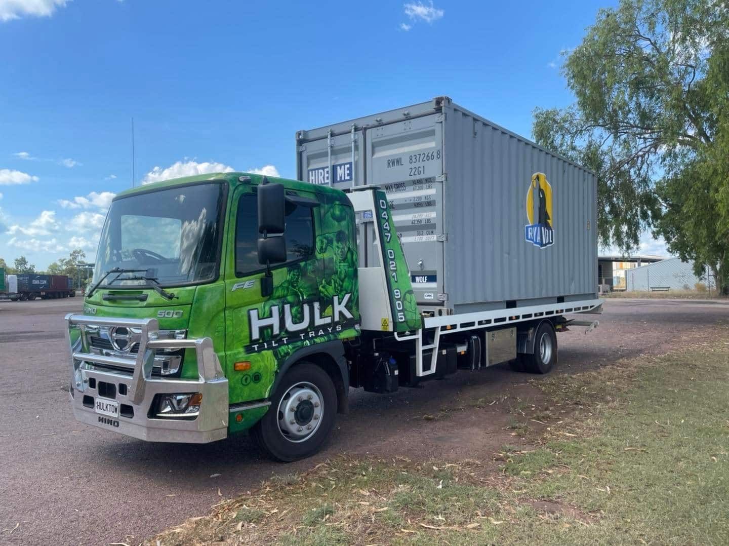 A Green Truck with A Container on The Back Is Parked in A Parking Lot — Hulk Tilt Trays In Palmerston, NT