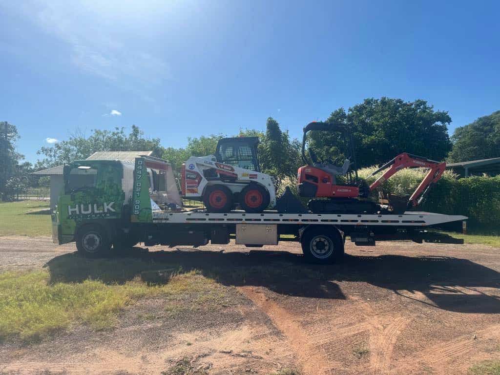 A Tow Truck Is Carrying a Bulldozer and An Excavator — Hulk Tilt Trays In Humpty Doo, NT