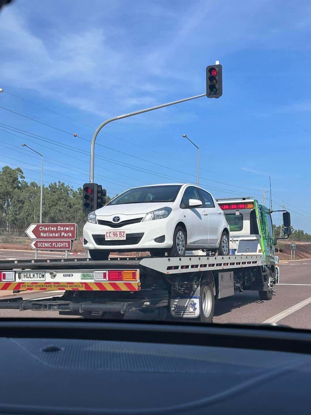 A White Car Is Being Towed by A Tow Truck — Hulk Tilt Trays In Humpty Doo, NT