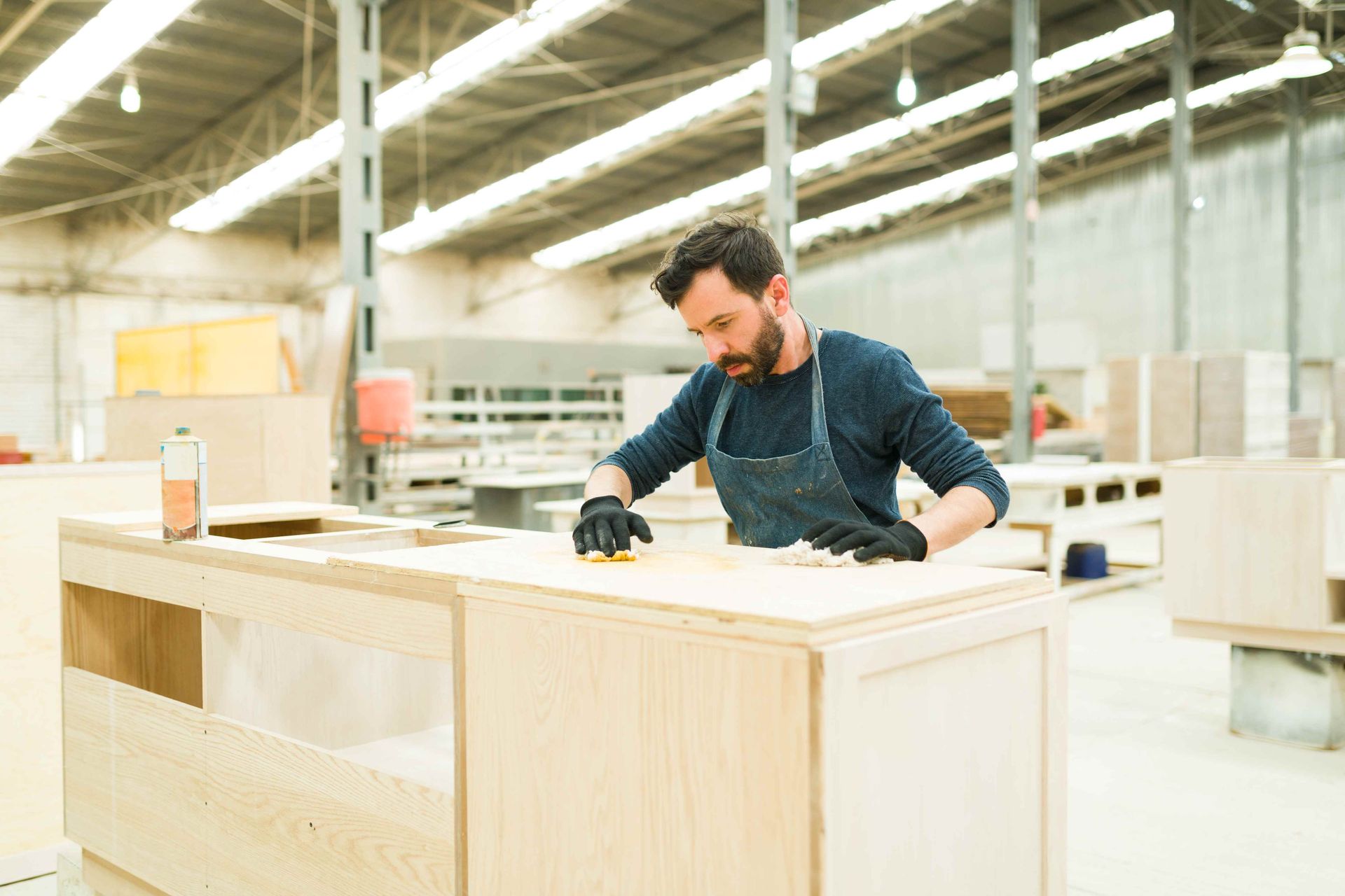 A man in his shop working on cabinets