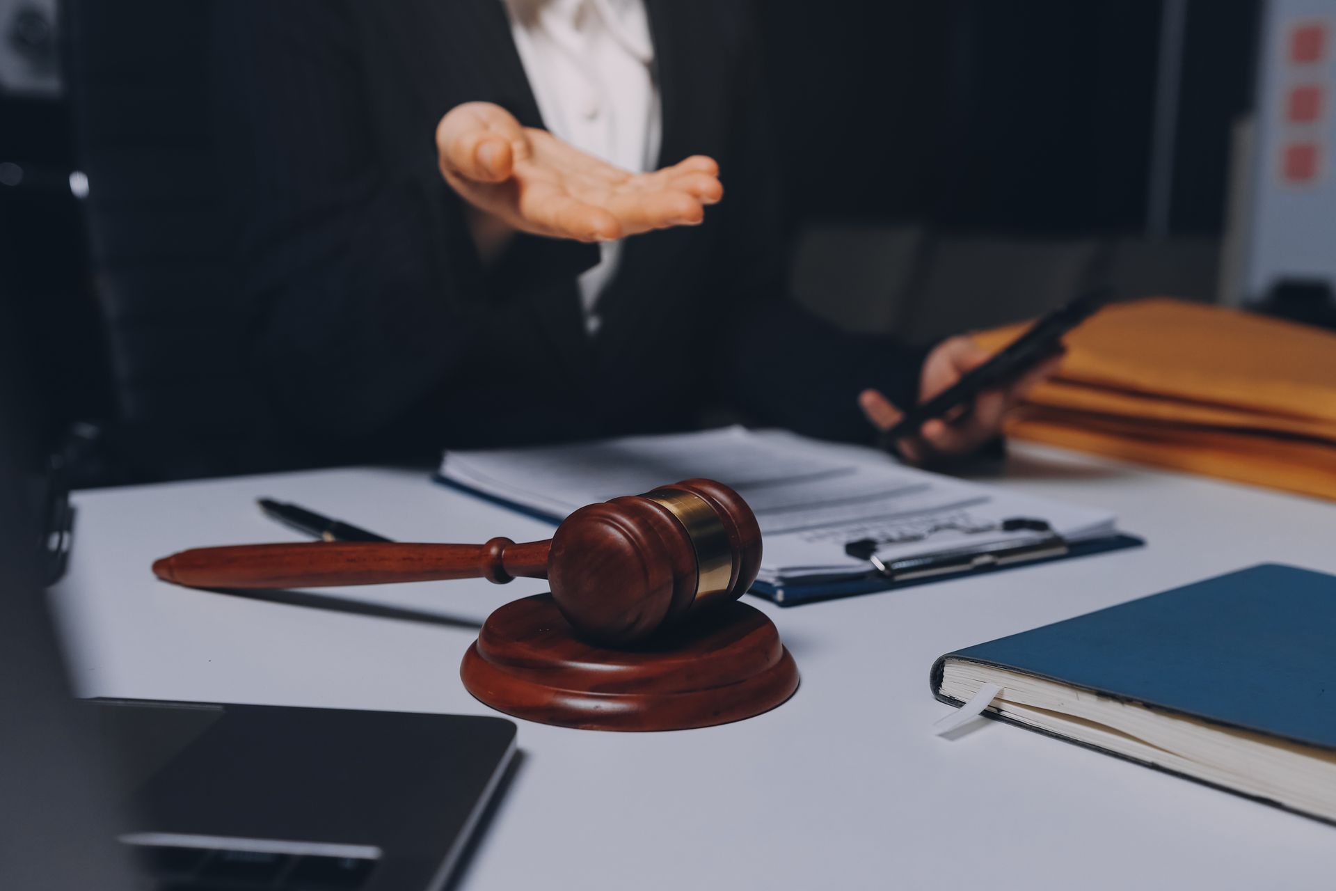 Gavel on desk beside papers and a broken arm, suggesting a legal injury case Gavel on desk beside papers and a broken arm, suggesting a legal injury case