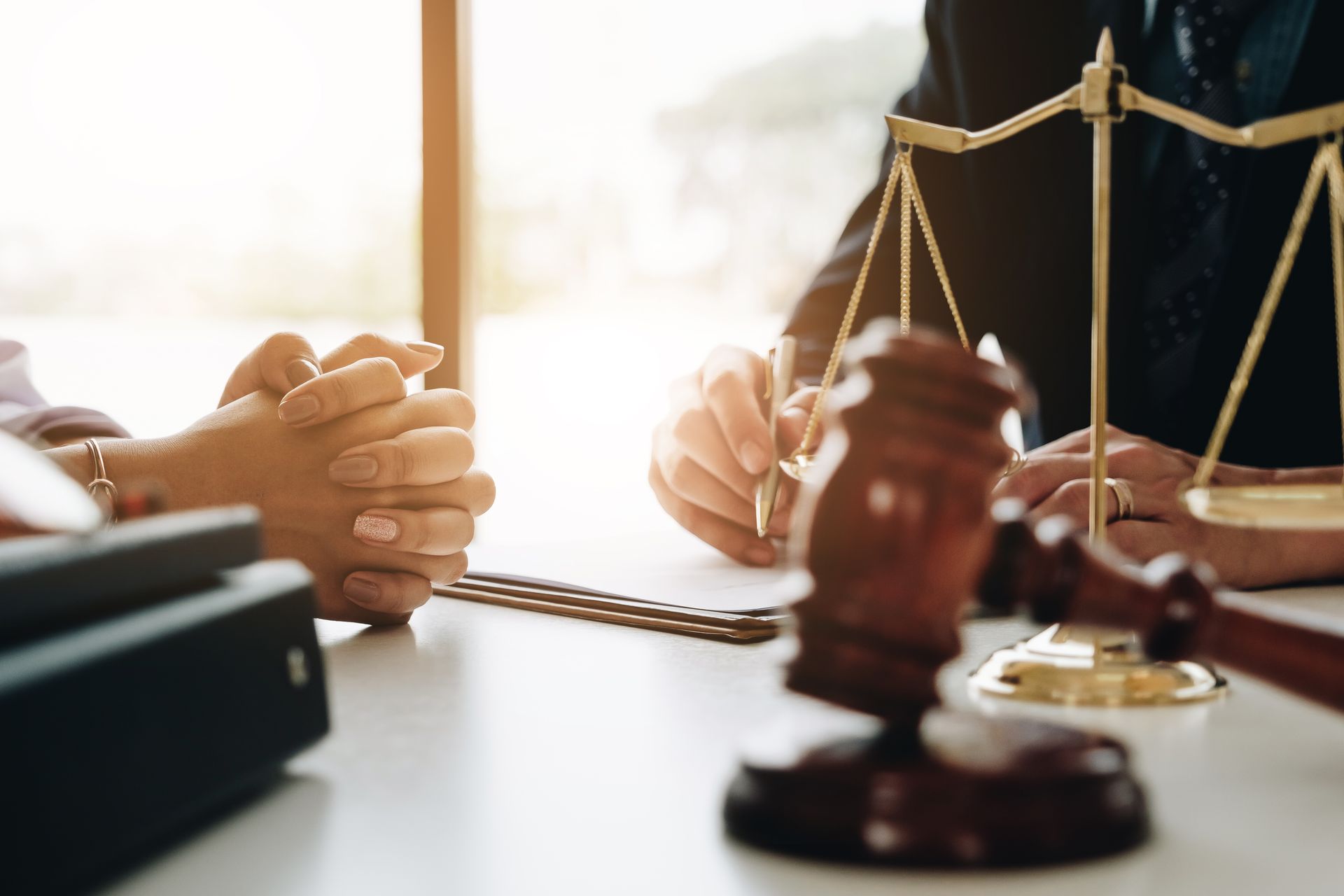 Lawyers in a meeting with a gavel and scales of justice on the table