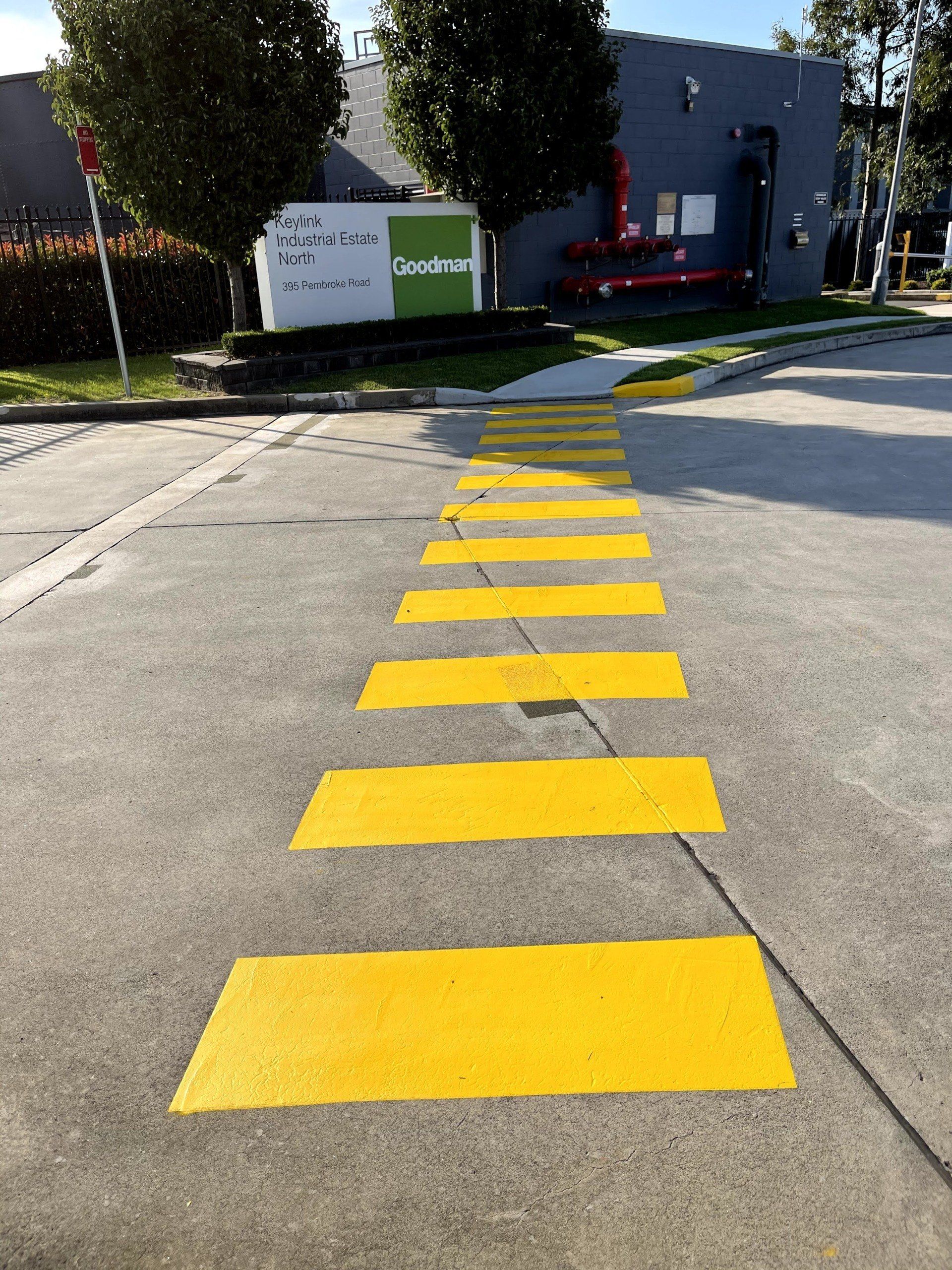 a row of yellow crosswalks painted on the side of a road