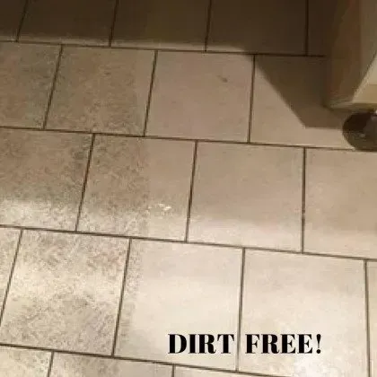 A dirty tile floor with the words `` dirt free '' written on it.