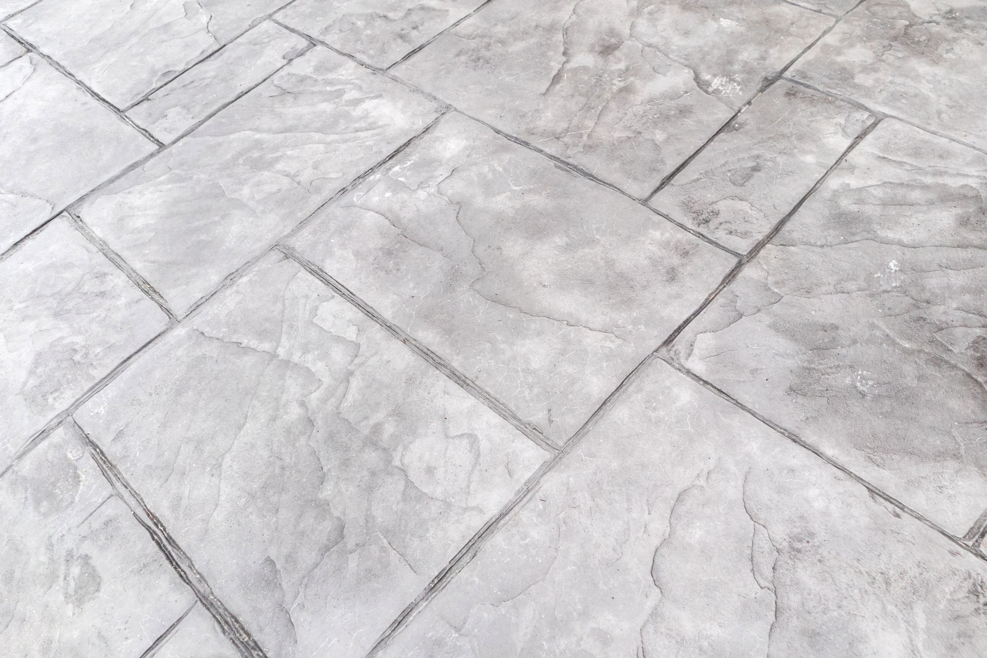 A close up of a concrete floor with a pattern of squares.