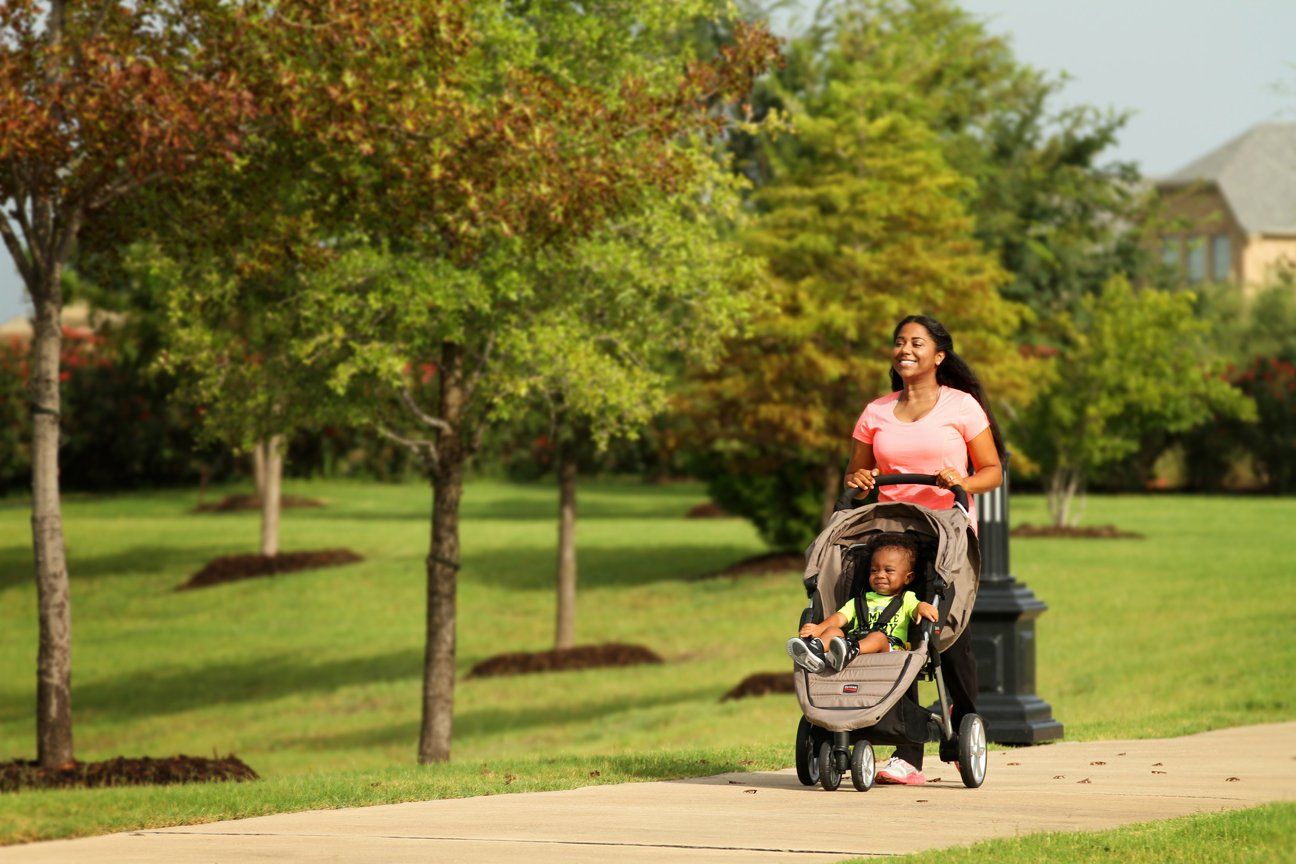 Mother Pushing a Stroller Along Devonshire Community Path | Devonshire Living | Forney, TX 75126