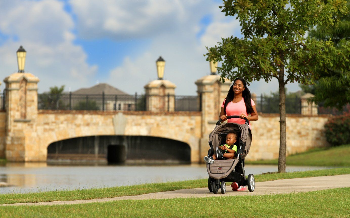 Woman Pushing a Stroller on Beautiful Outdoor Path | Devonshire Living | Forney, TX 75126