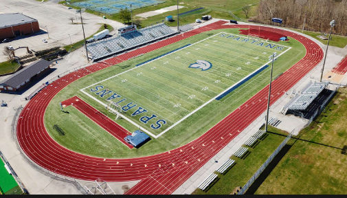 An aerial view of a football field with a track in the middle.