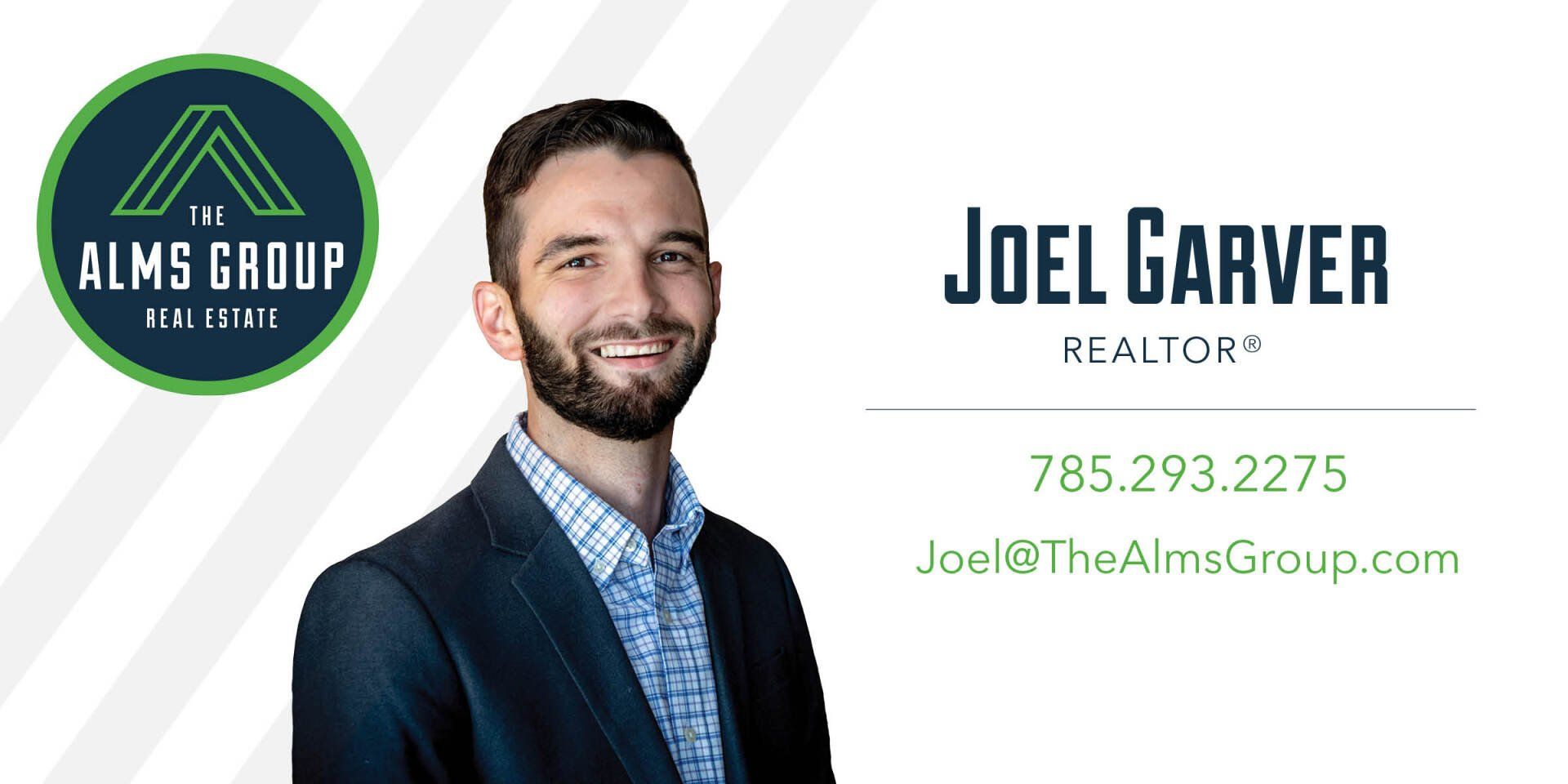 A man with a beard is standing in front of a business card for a real estate agent.