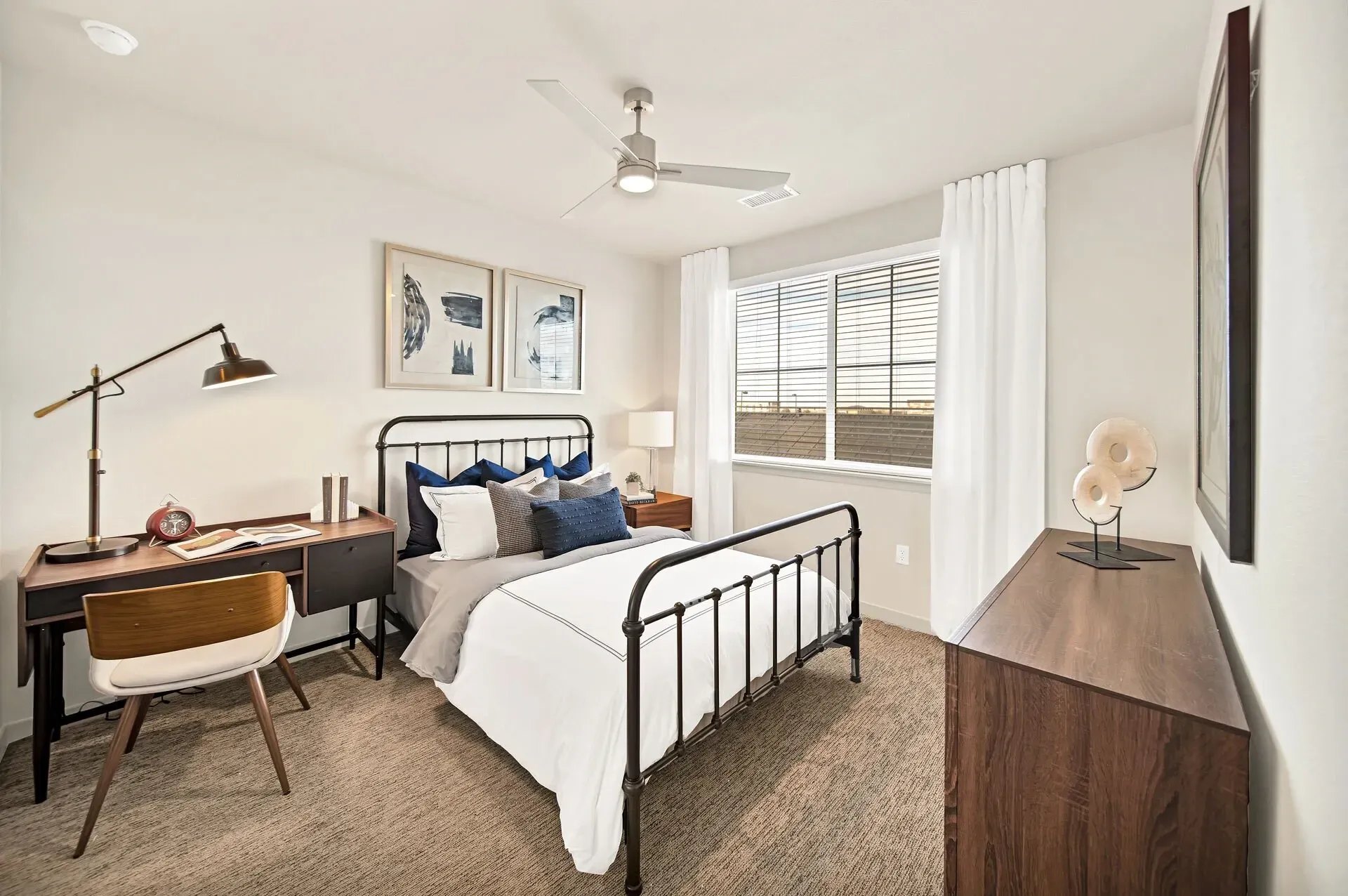 Bedroom with a desk, bed, and dresser.