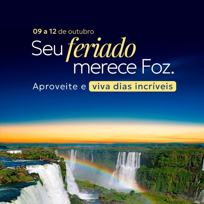 Vista aérea das Cataratas do Iguaçu com arco-íris e texto promocional “Seu feriado merece foz” sobre fundo azul.