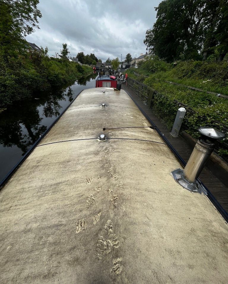 A boat is going down a river on a cloudy day