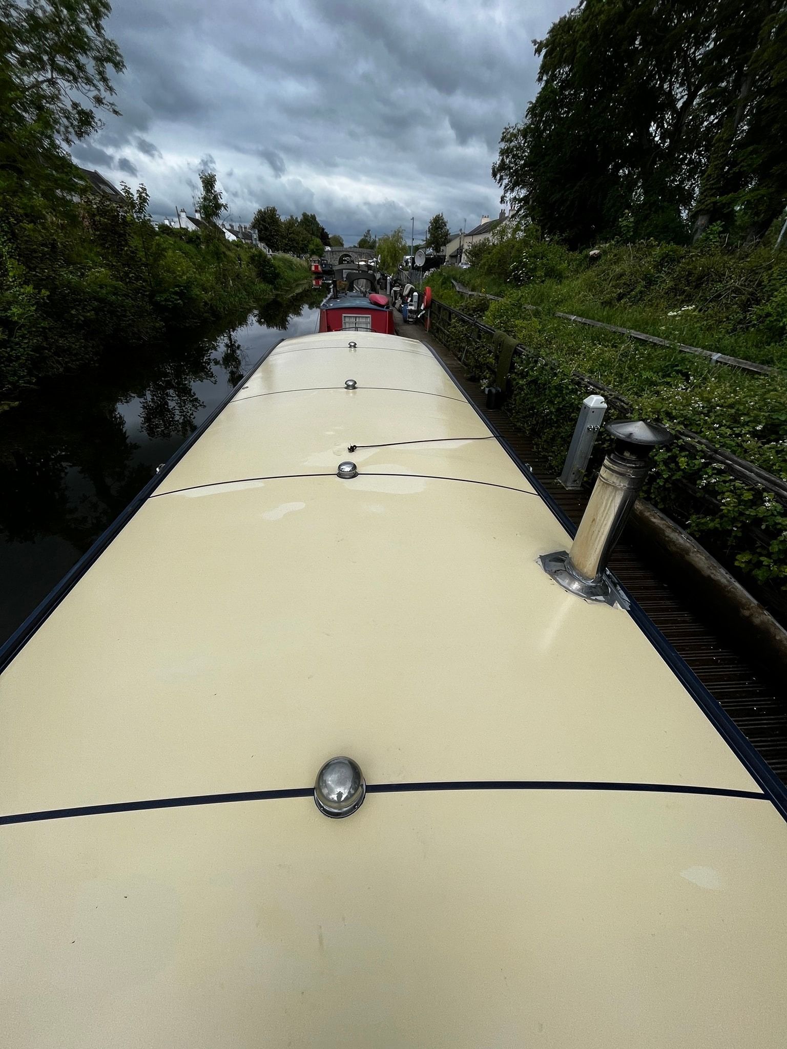 A boat is going down a river on a cloudy day