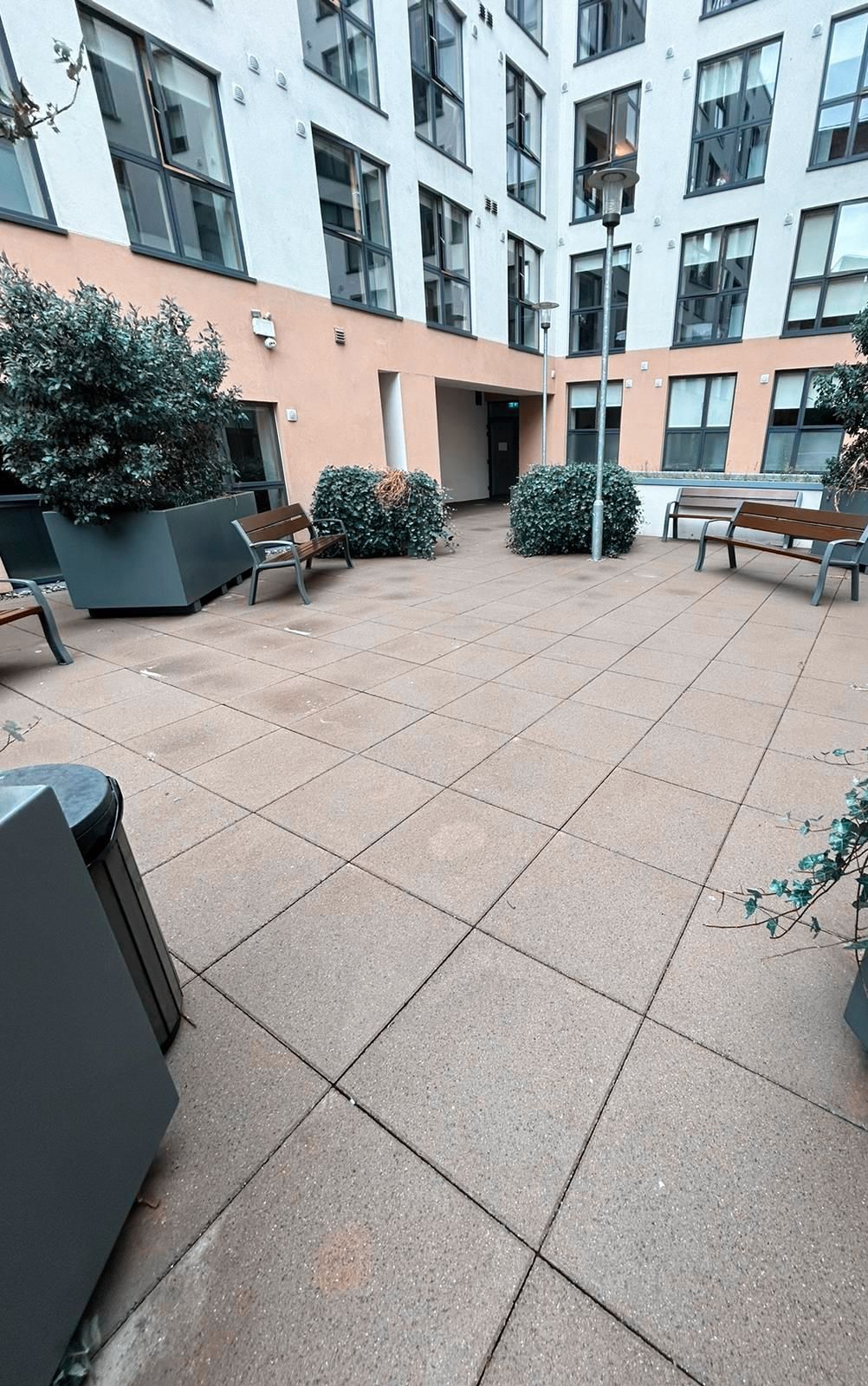 A large building with a patio in front of it.