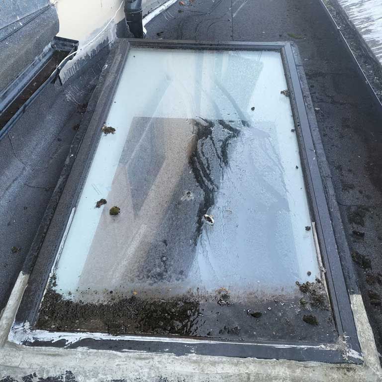 A dirty skylight on the roof of a building