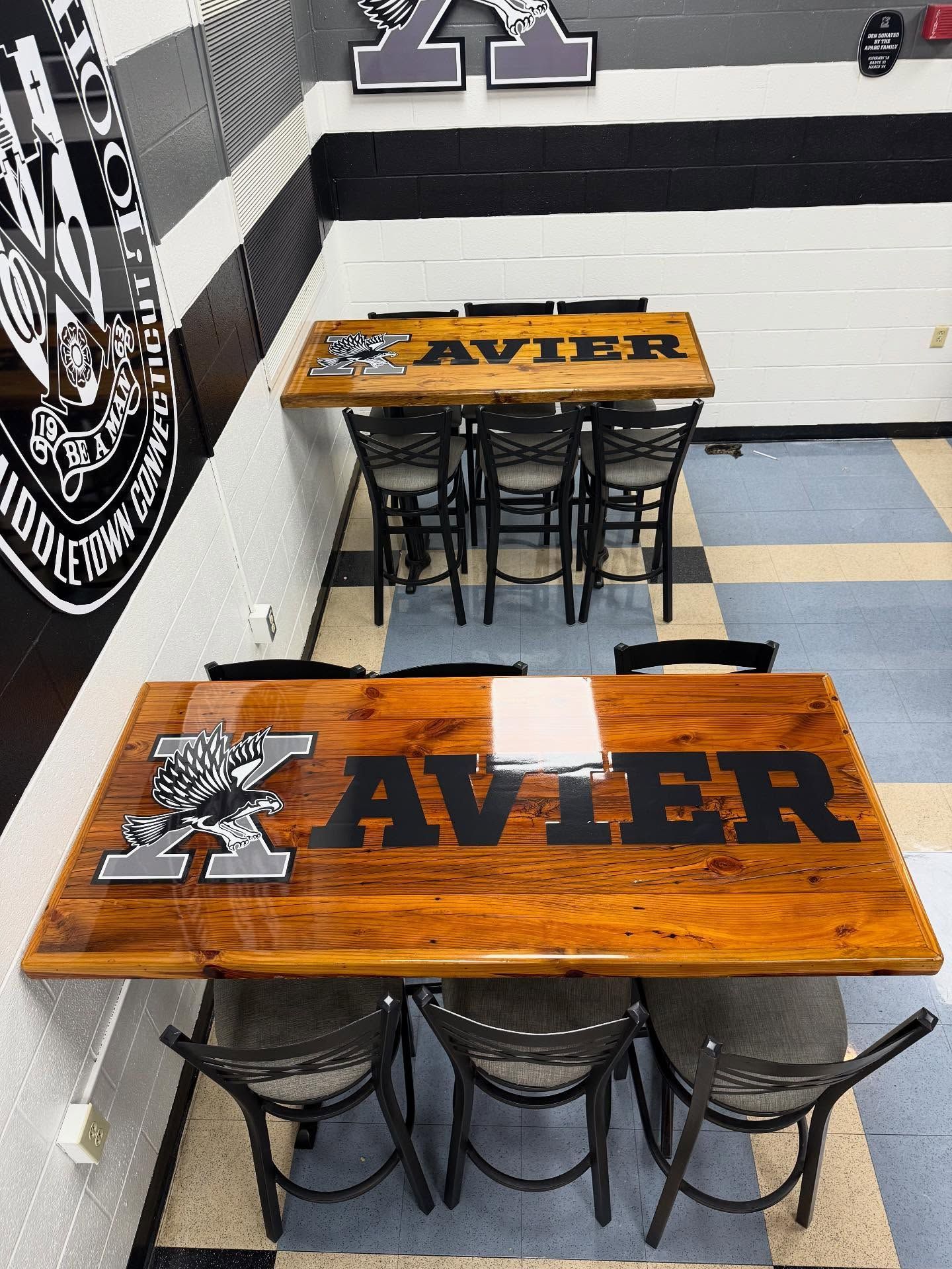 Two wooden tables with black 