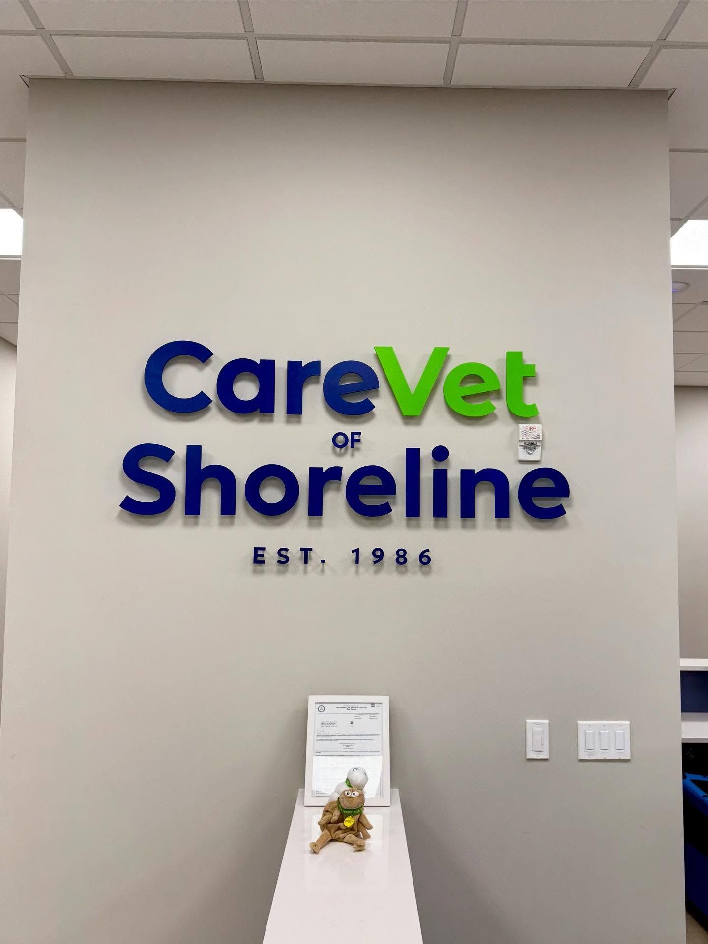 CareVet of Shoreline sign, blue and green lettering on a gray wall. Est. 1986 below.
