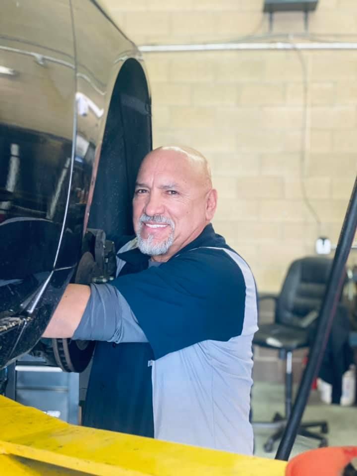 Friendly Mechanic Working Beneath Vehicle Lift | Roy's Auto Service