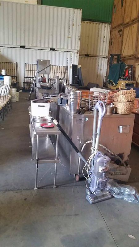 A Warehouse Filled With Lots Of Appliances And A Vacuum Cleaner — Dawson Moving & Storage NQ in Melbourne, VIC