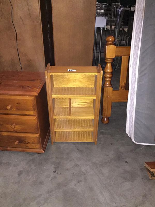 A Small Wooden Bookshelf Is Sitting Next To A Dresser And A Bed — Dawson Moving & Storage NQ in Townsville, QLD
