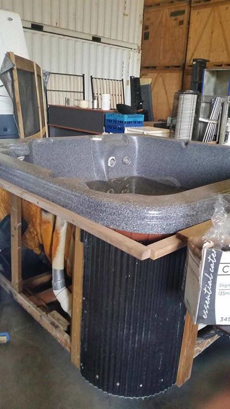 A Hot Tub Is Sitting On Top Of A Wooden Crate In A Warehouse  — Dawson Moving & Storage NQ in Canberra, ACT