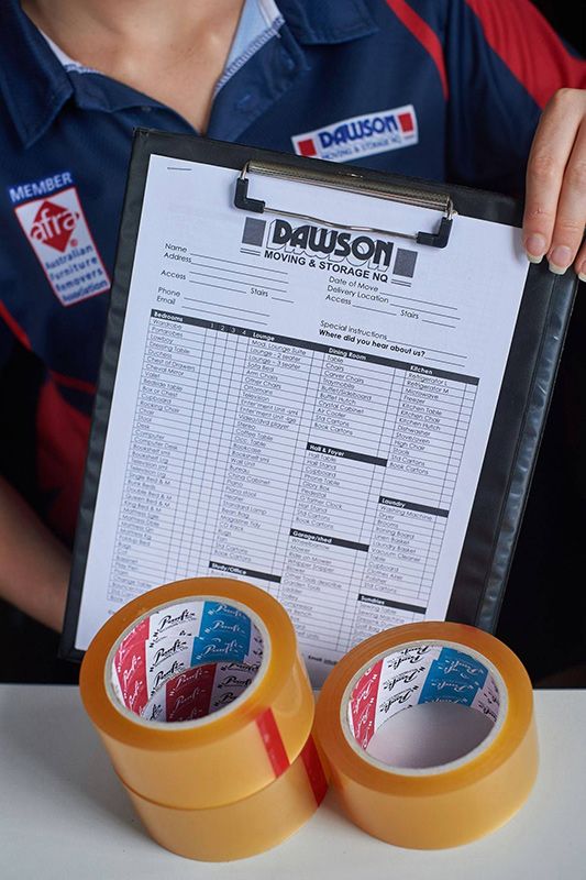 A Woman Is Holding A Clipboard With Tape — Dawson Moving & Storage NQ in Mount St John, QLD
