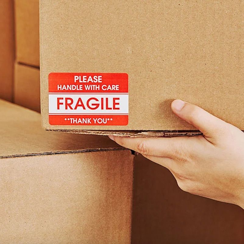 Man Moving The Fragile Label Boxes— Dawson Moving & Storage NQ in Melbourne, VIC