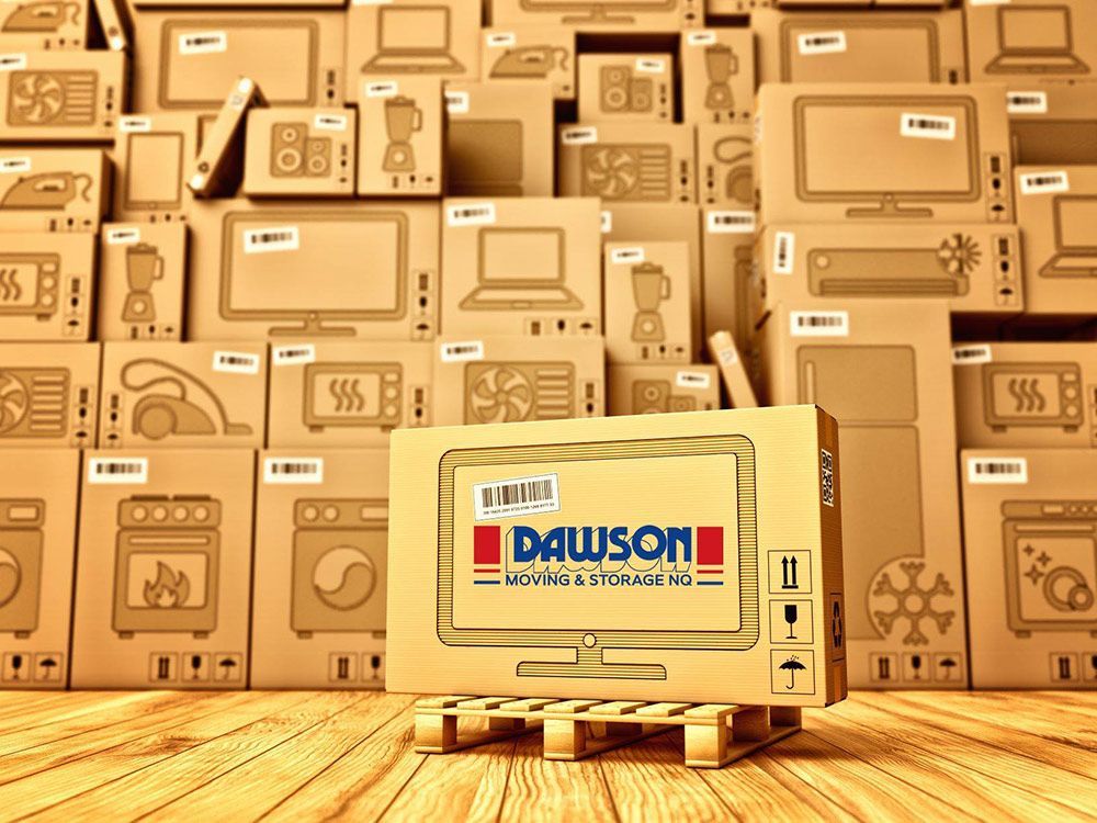 A Cardboard Box With The Word Dawson On It Is Sitting On A Wooden Pallet — Dawson Moving & Storage NQ in Mount St John, QLD